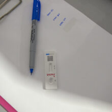 Clipboard with pen and rapid COVID test